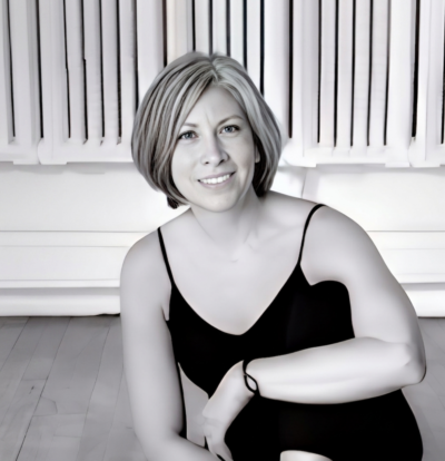 Smiling woman in black tank top.